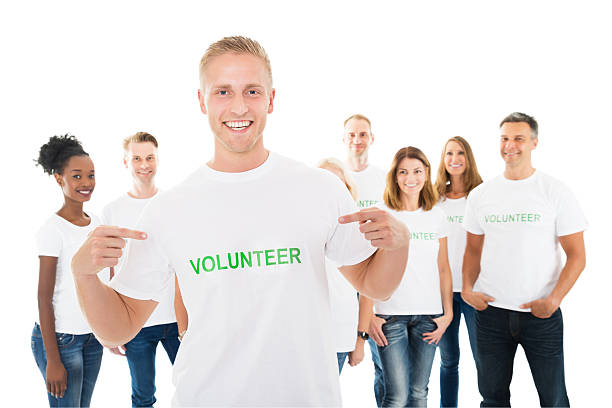 istock Happy Man Showing Volunteer Text On Tshirt 614431214