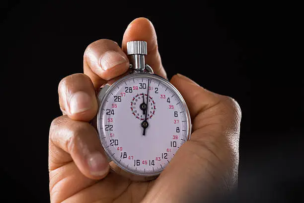 Photo of Person Hand Holding Stop Watch