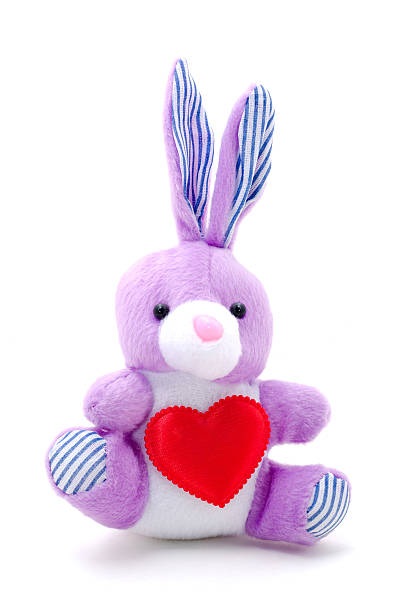 istock light purple toy bunny rabbit sitting with heart. 614432852