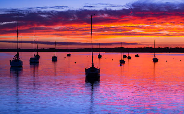 istock Sun sets over Poole Harbor, Dorset at Hamworthy pier jetty 614434086