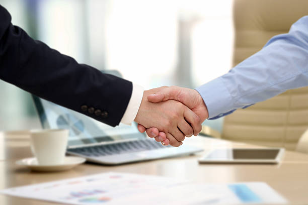 istock The firm handshake  between two colleagues in office. 614434526
