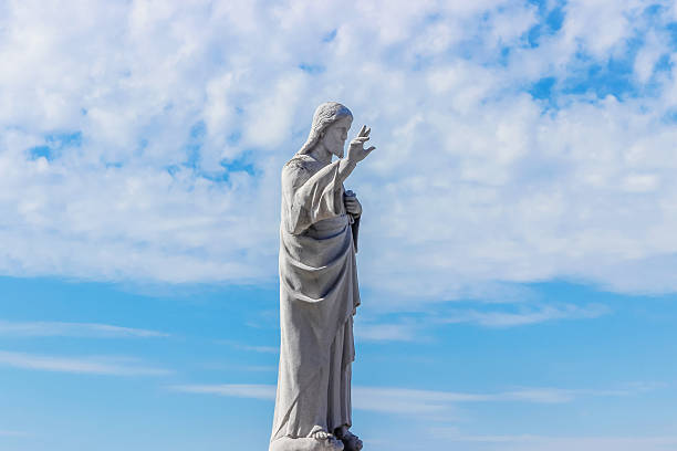 istock statue of jesus in blue sky 614435608