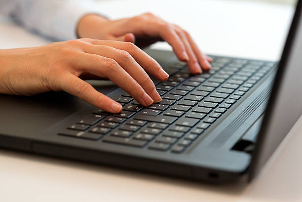 istock Woman's hand typing on laptop keyboard 614437076