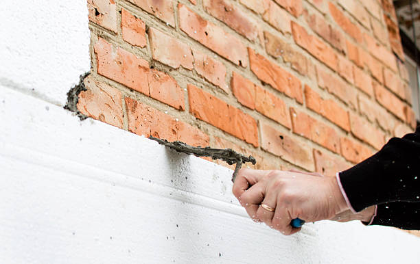 istock Putting glue on styrofoam on the brick wall 614437918