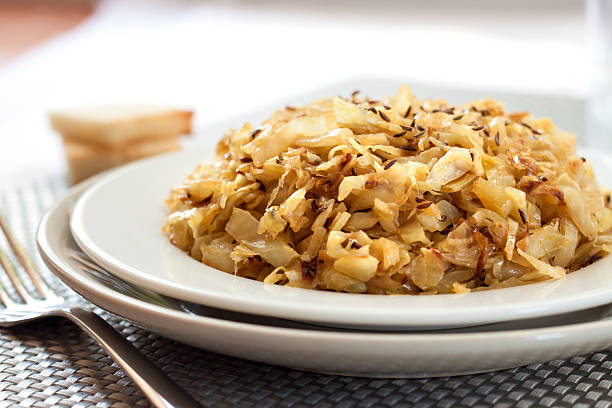 istock Fried cabbage with caraway and garlic on a plate 614438084