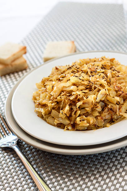 istock Fried cabbage with caraway and garlic on a plate 614438278