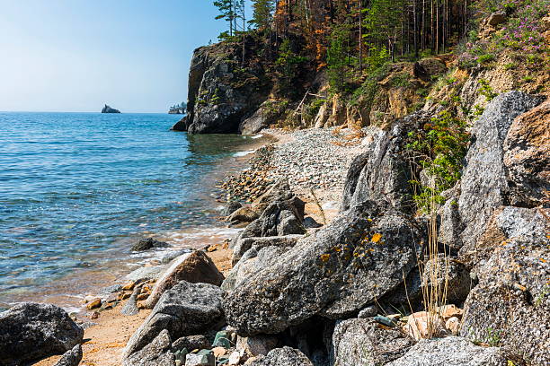 istock The lake shore is covered with stones 614438324