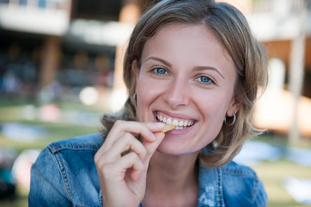 istock Woman eating fries 614438526