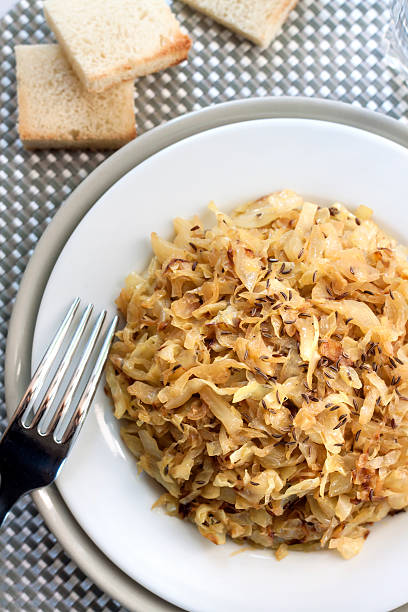 istock Fried cabbage with caraway and garlic on a plate 614439084