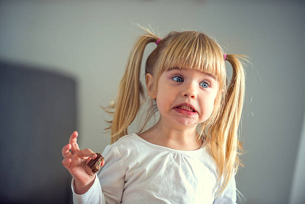 Cute little girl eating chocolate