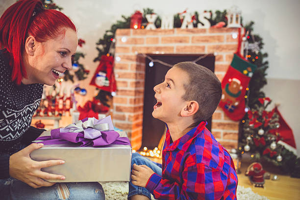 istock Mother give little son christmas gift. 614441358