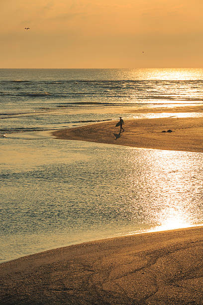 istock Small Island With Surfer on Sunrise 614441398