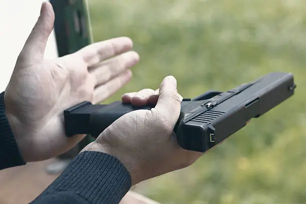 Photo of Loading Handgun. Reloading handgun.