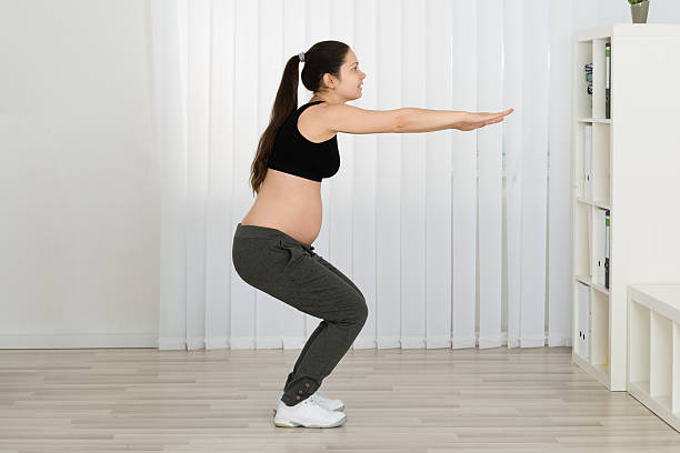 istock Young Pregnant Woman Doing Workout 614442722