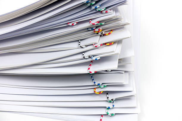 istock reports with colorful paper clip place on white background 614443472