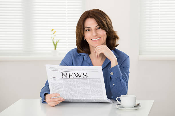 istock Woman Reading Newspaper 614445736