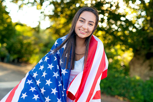 istock Young ethnic female wearing an American flag 614446816