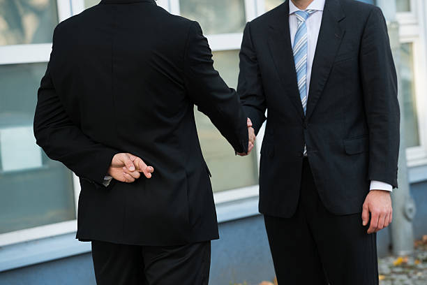 Dishonest Businessman Shaking Hands With Partner