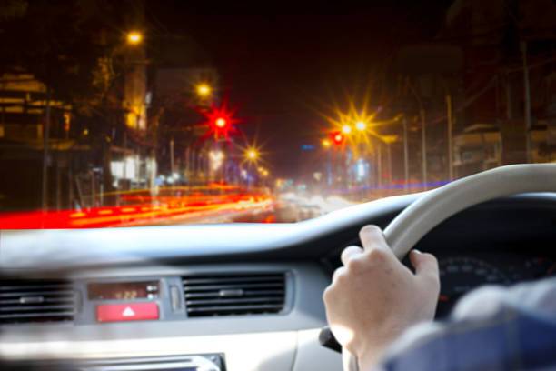 istock blurry man driving car on the road at night 614449208