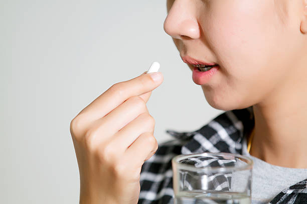 istock Asian women are taking medicines and vitamins for help Sick 614490872