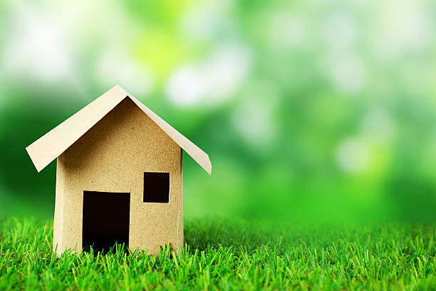 istock Paper house model and blur green background. 614491158