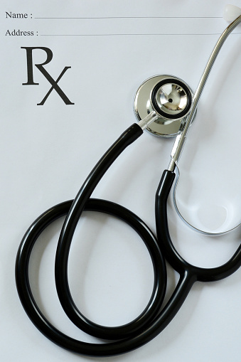 Black stethoscope and medical prescription.