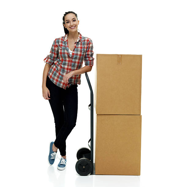 istock Smiling female leaning on hand truck 614491982