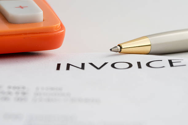 istock Invoice letter head with pen and calculator 614492730