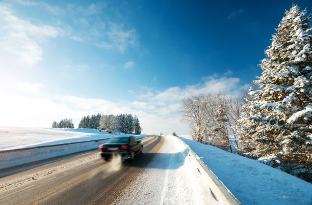 istock Car tires on winter road 614498566