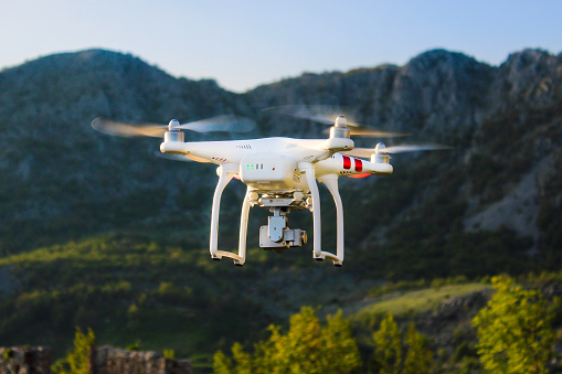 Budva, Montenegro - May 10, 2016: DJI Phantom 3 flying. Phantom is a series of unmanned aerial vehicles (UAVs) developed by the Chinese company DJI. These non-military quadcopters or drones are intended for recreational and commercial aerial cinematography and photography.