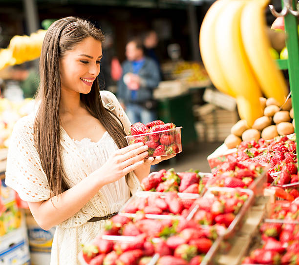 istock Young woman  at the market 614501214
