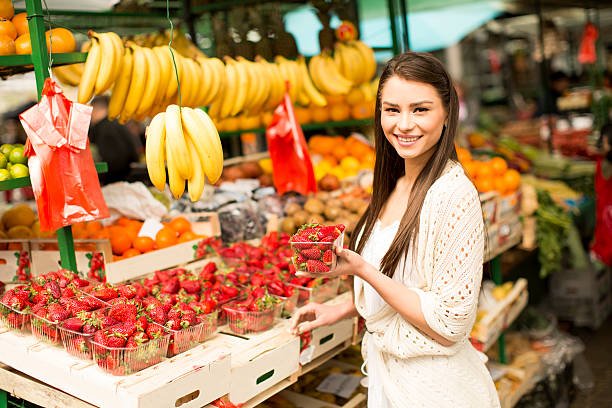 istock Young woman on the market 614501236