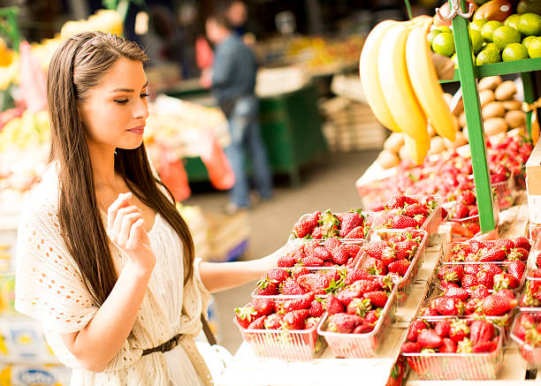 istock Young woman on market 614501256