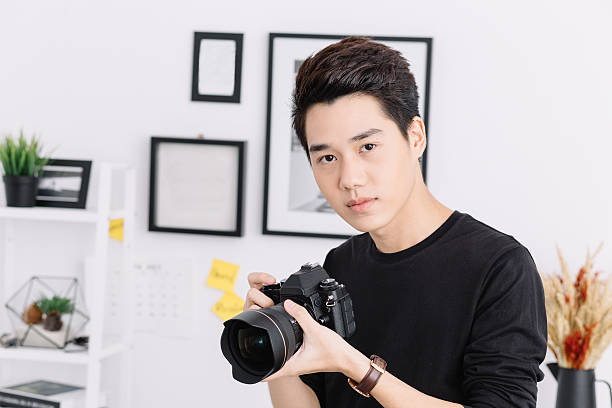 istock Young asian photographer 614502658