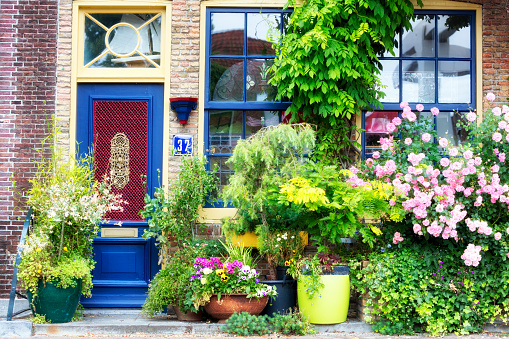 Brielle, Netherlands - July 5, 2015: Beautiful facade of an old house decorated with flowers in the historical city of Brielle in the Netherlands, Europe.