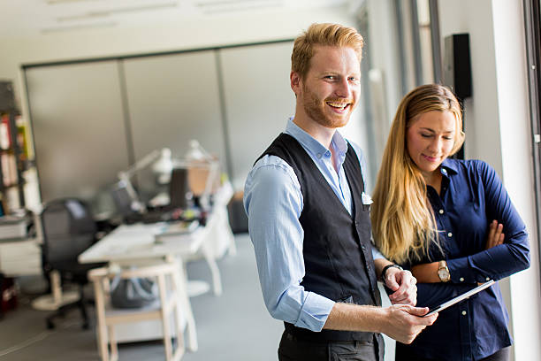 istock Man and woman with tablet 614505336