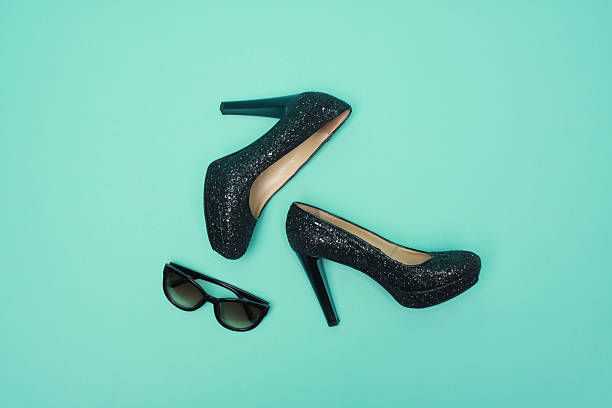 istock close up black heels in turquoise background 614506274