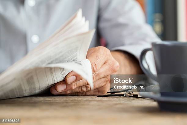 Man Newspaper Reading On Table Stock Photo - Download Image Now - Newspaper, Reading, The Media