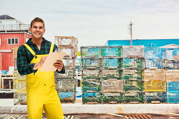 istock Fisherman writing on clipboard in shipping industry 614508156