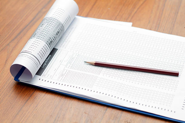 istock glasses and pencil on Standardized test form with answers bubble 614508370
