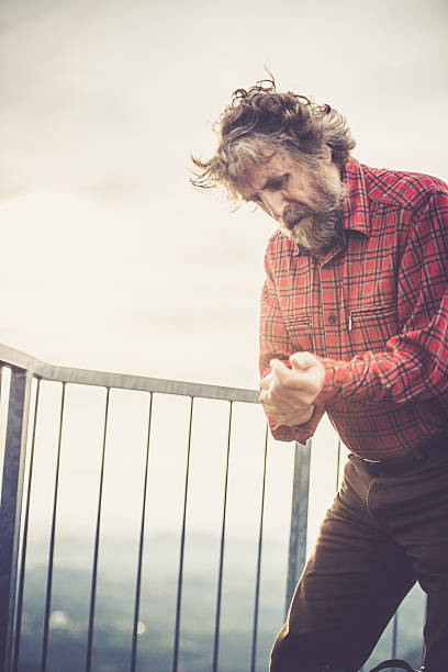 istock Senior Man Hiking and changing clothes on the hill top 614508580