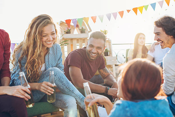 istock Friends drinking beer on the rooftop 614508958