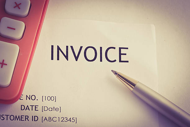 istock Invoice letter head with pen and calculator / selective focus 614510932