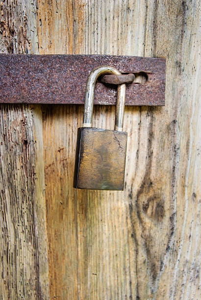 istock Padlock on an old wooden door 614510964