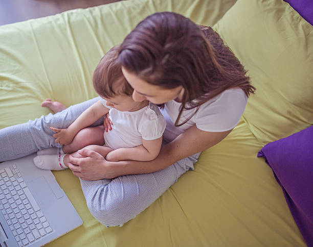 istock Mom and daughter on laptop 614511356