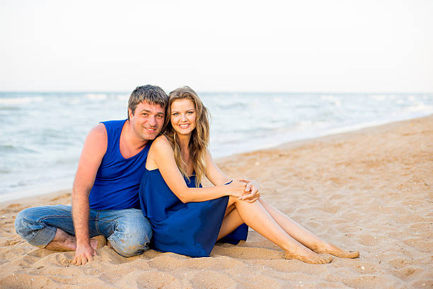 istock Man and woman at the beach 614512042