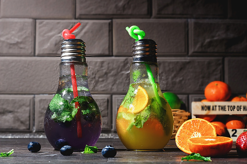 Fruity Mojito cocktail in bottle shaped like a lamp.