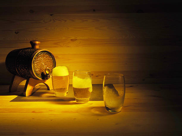 Barrel and glass of light beer on a wooden background