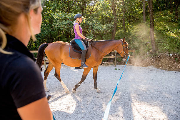 istock Young Woman Taking Horseriding Lessons 614513198