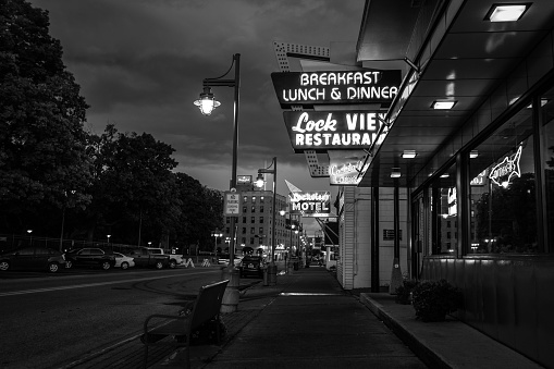 Sault Ste. Marie, Michigan, USA - September 18, 2016: Sidewalk and retro neon signs on the streets of  downtown Sault Ste. Marie, Michigan.